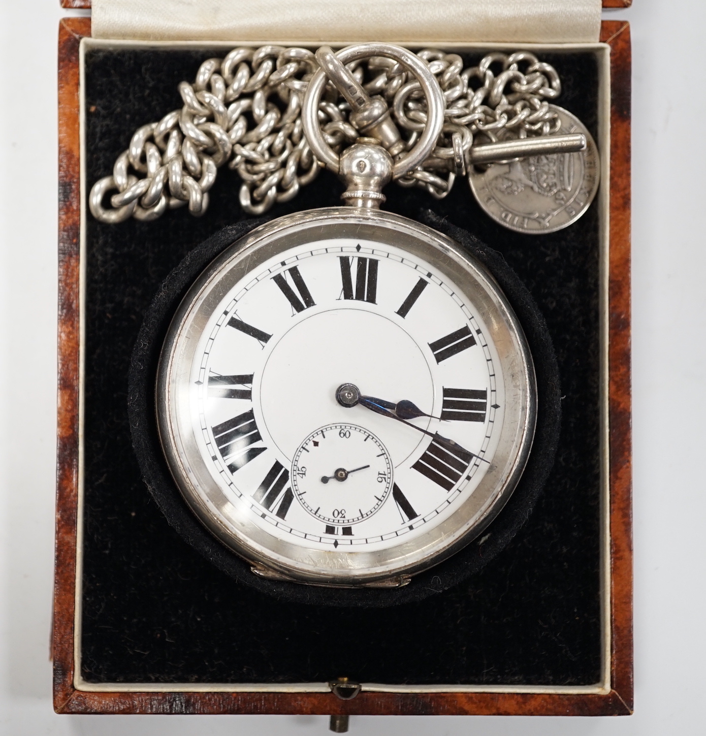 A Swiss 935 white metal open faces keyless pocket watch, with Roman dial and subsidiary second, on a silver albert.